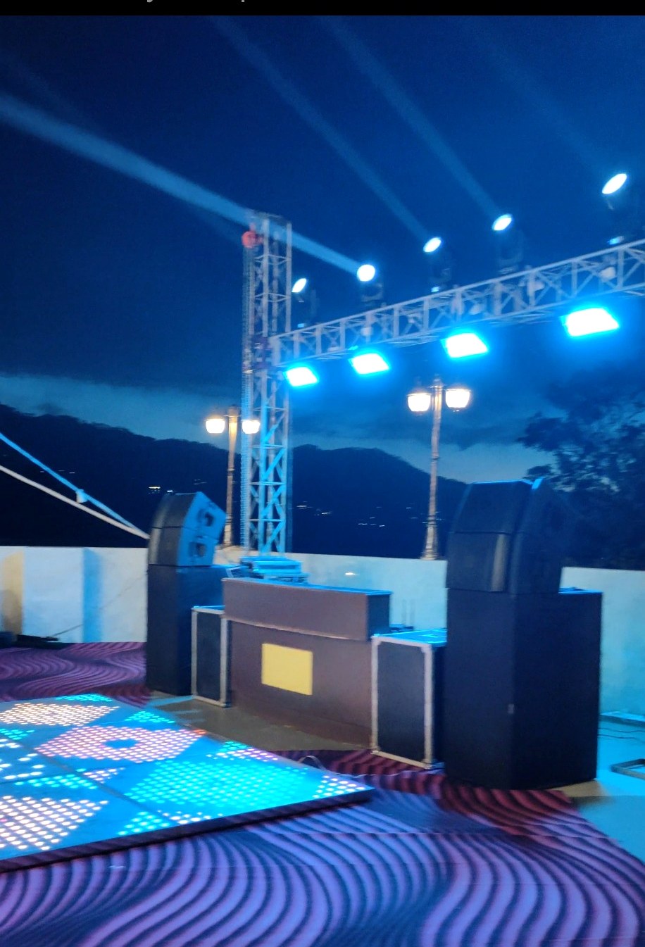 DJ console, speakers and LED dance floor setup
